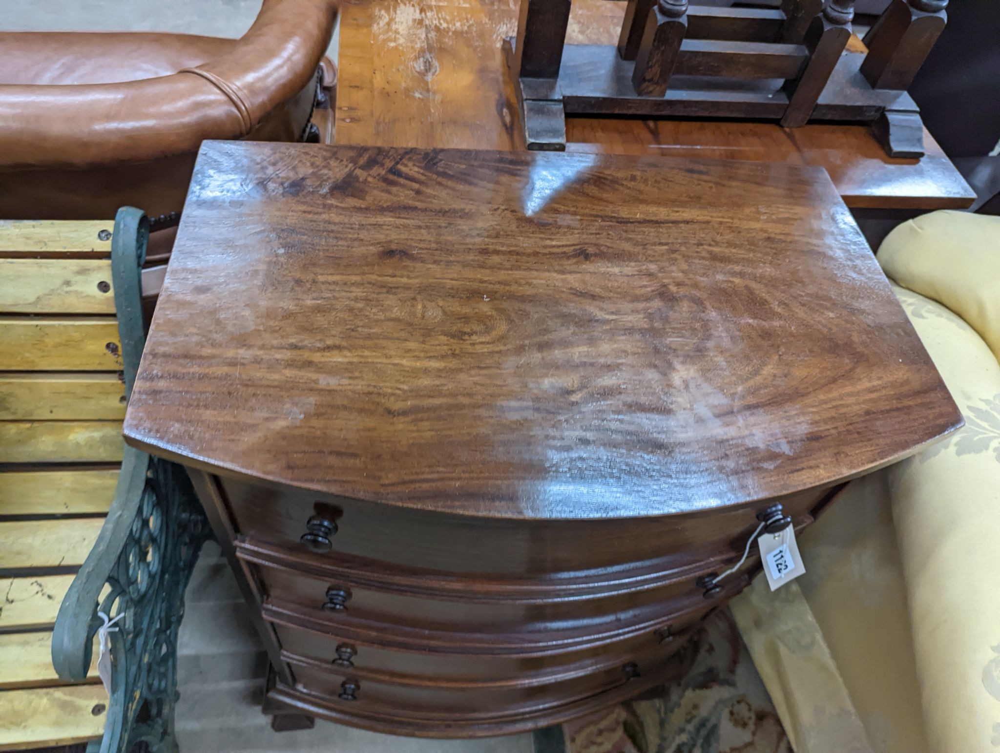 A small reproduction mahogany bow front chest of four long drawers, width 60cm, depth 38cm, height 82cm